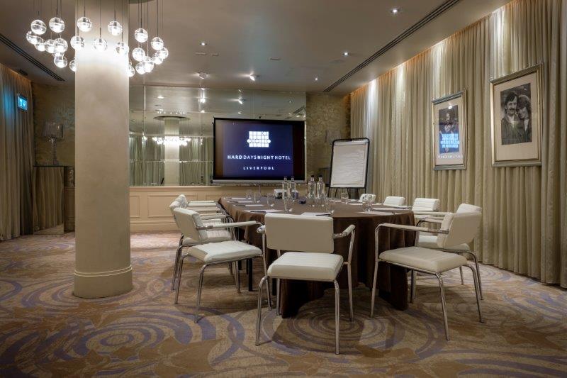 Meeting room with central table and modern chairs at Hard Days Night Hotel. - Banner