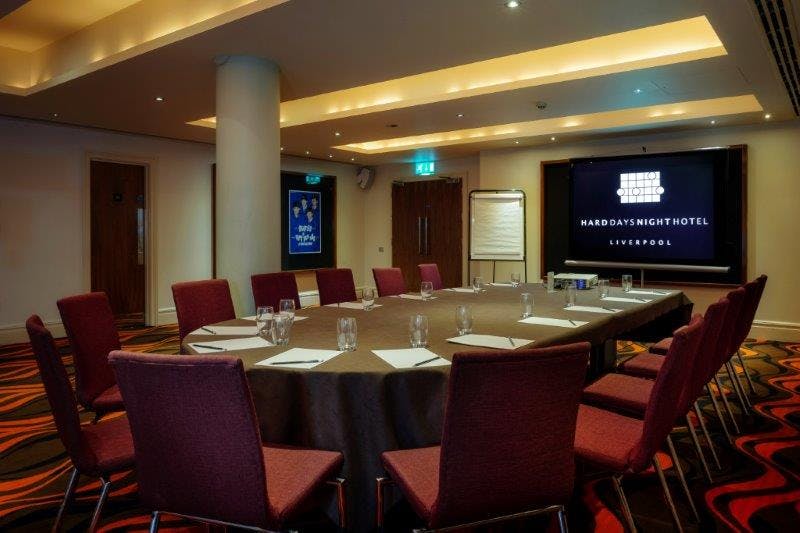 Hard Days Night Suite meeting room with round table, ideal for corporate events and workshops.