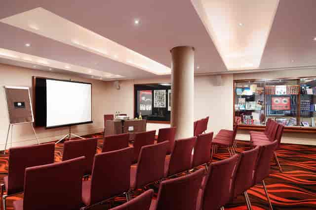 Hard Days Night Suite meeting space with projector, ideal for workshops and conferences.