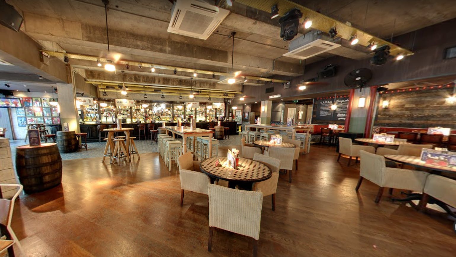 Full Venue Hire at Revolucion De Cuba Cardiff, modern industrial event space with warm lighting.