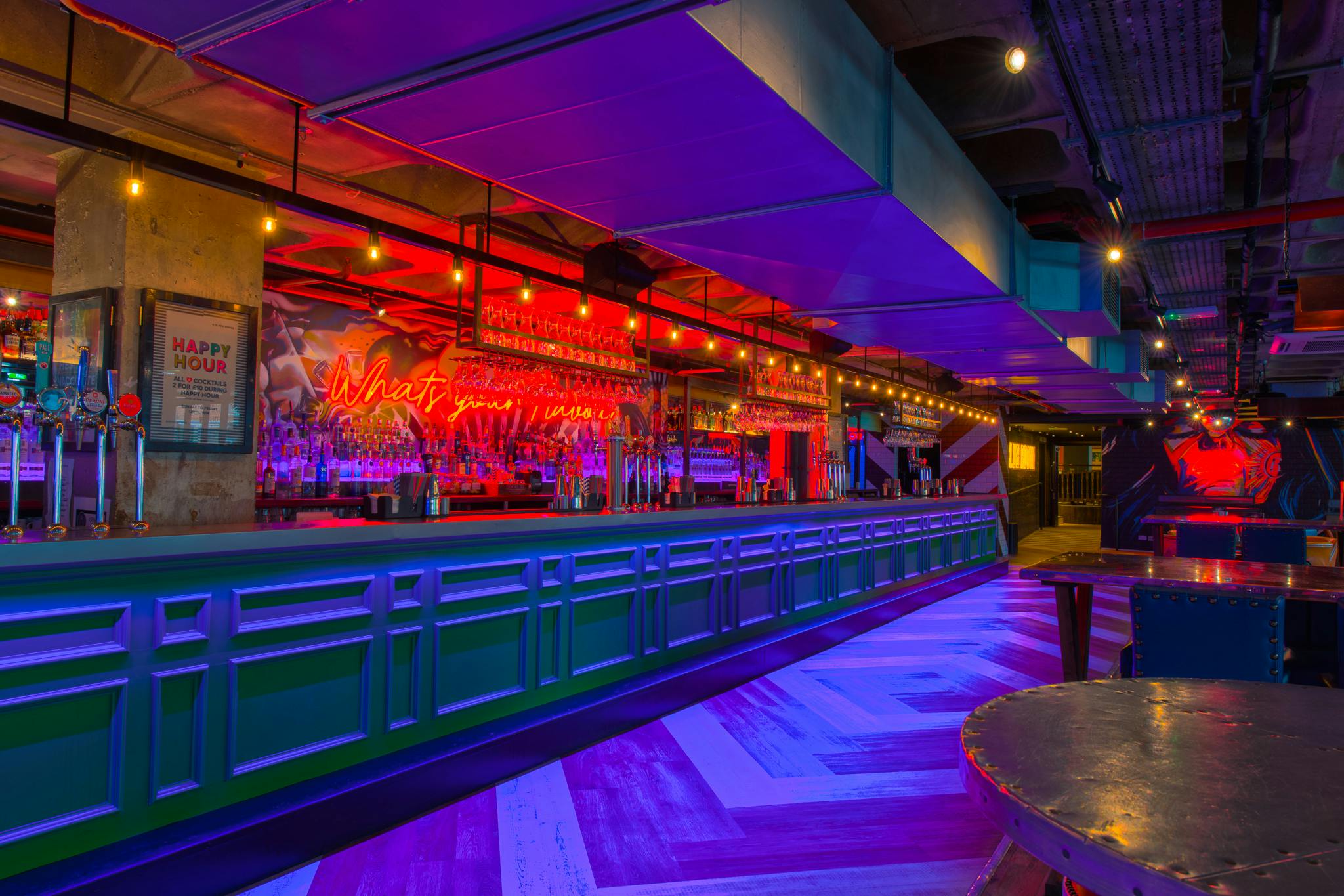 Vibrant event space with stylish bar and colorful lighting at Revolution Ipswich.