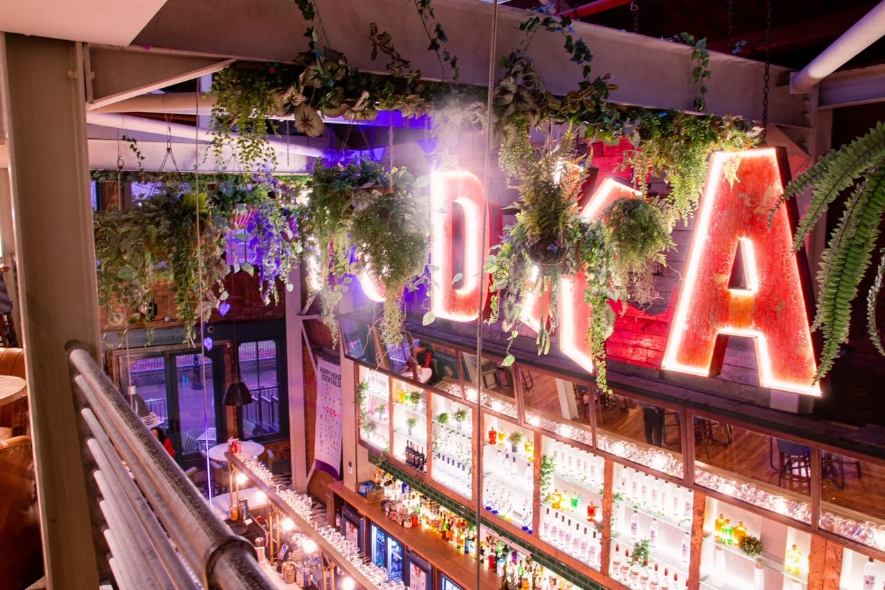 Vibrant Mezzanine bar in Revolution Leicester, ideal for social events and networking. - Banner
