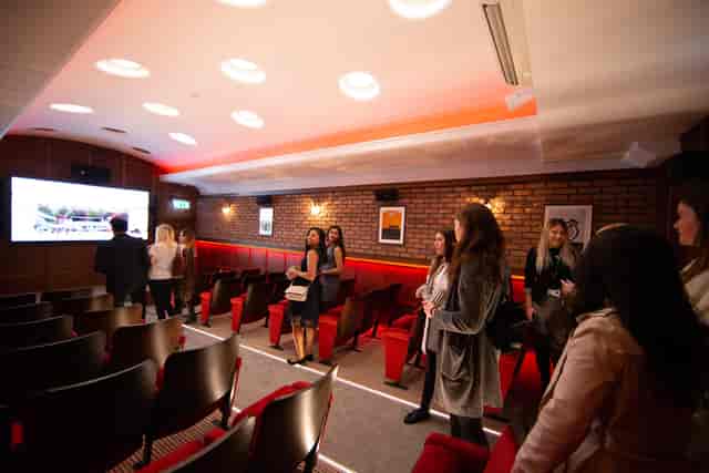 Modern meeting space at The Cutting Room, featuring comfortable seating and multimedia setup.