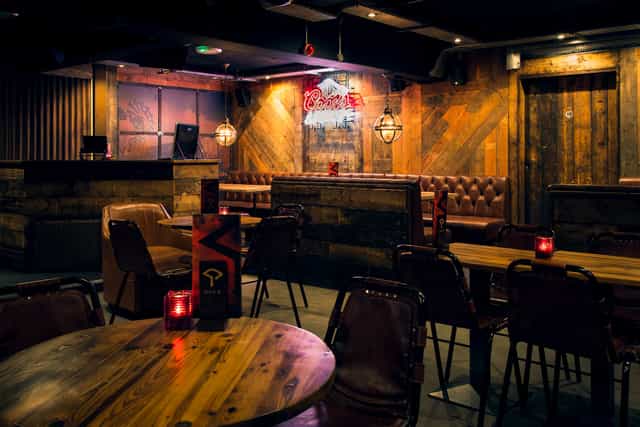 Intimate event room with rustic decor, perfect for gatherings and networking events.