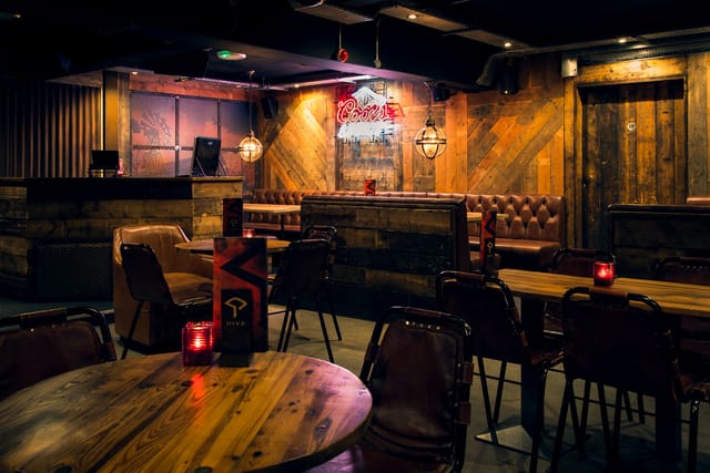Intimate event room with rustic decor, perfect for gatherings and networking events.