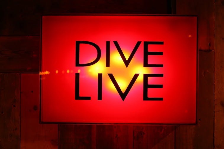 Vibrant Dive NQ venue with "DIVE LIVE" sign, ideal for engaging live events.