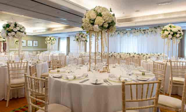 Elegant banquet hall with floral centerpieces for weddings and corporate events.