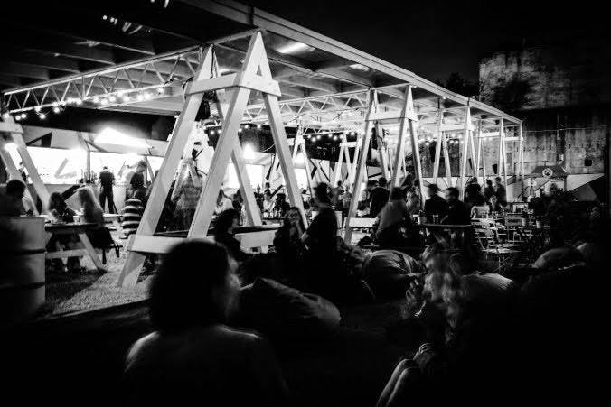 Vibrant outdoor event space at night in PITCH Stratford, ideal for networking and socializing.