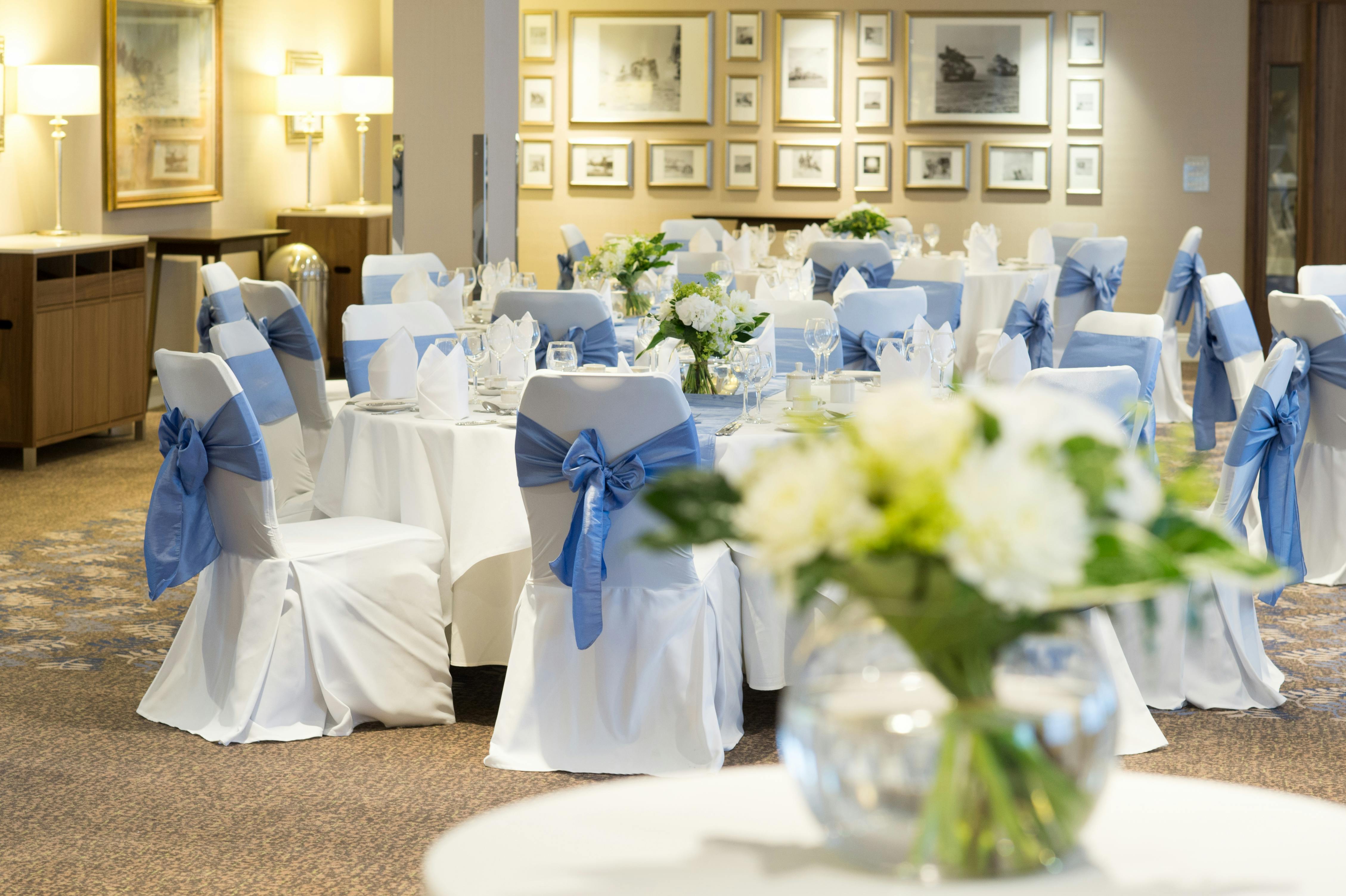 El Alamein Room at Victory Services Club, elegant wedding venue with floral centerpieces.