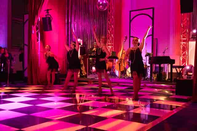 "Christmas party dance performance at Freemasons' Hall with vibrant decor and ambiance."