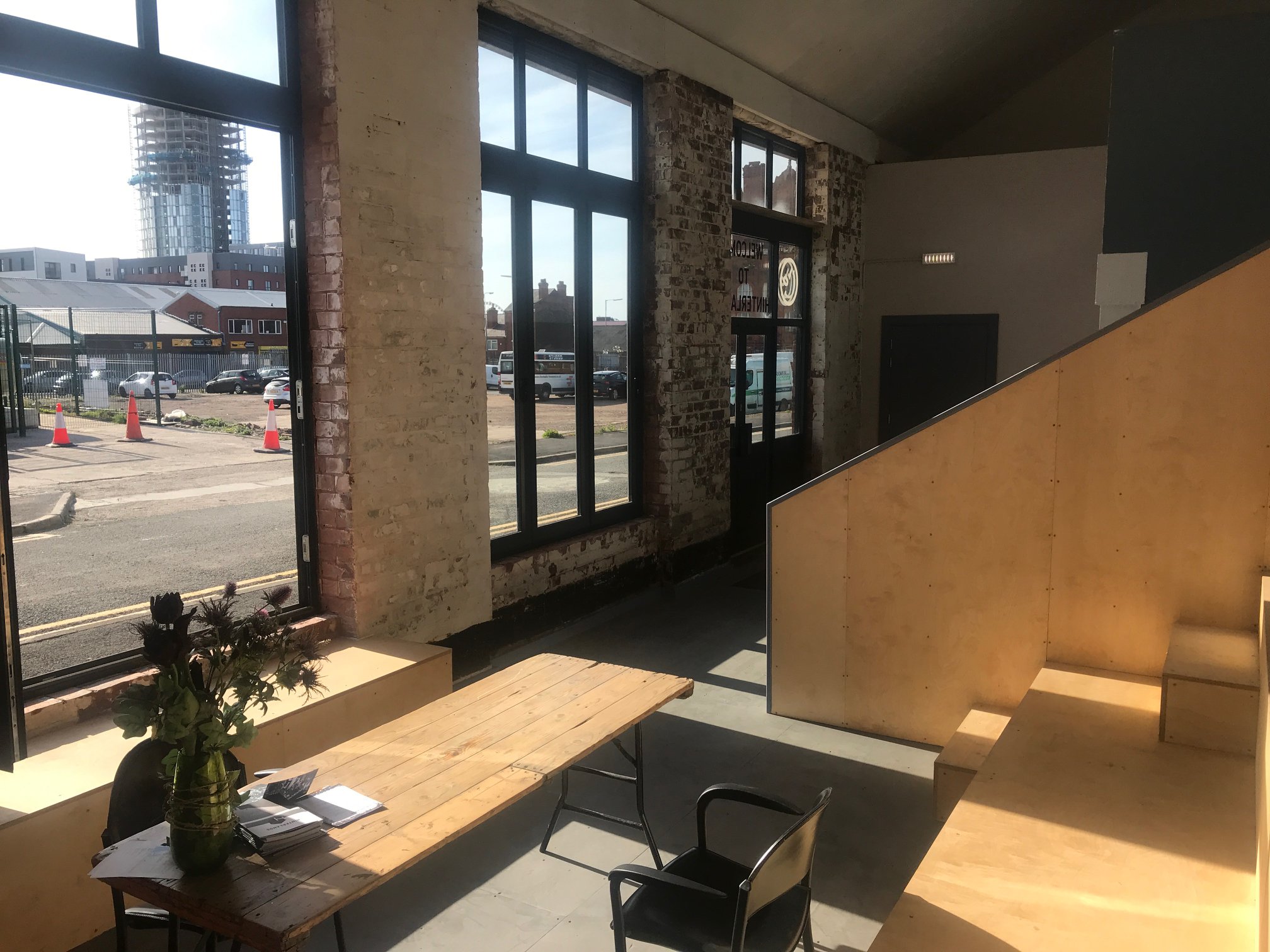 Modern industrial reception space with exposed brick for events and meetings.