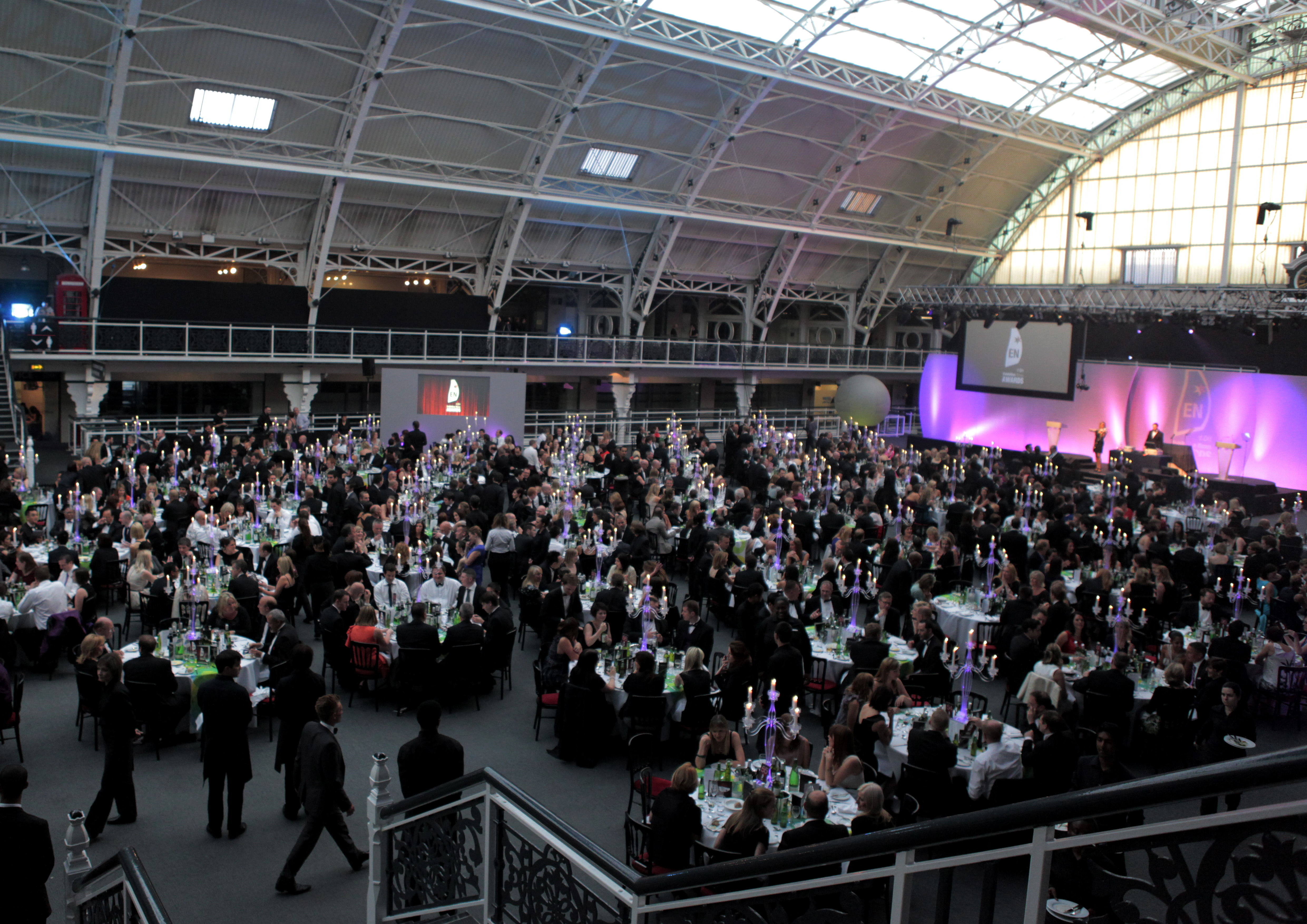 Large event at Business Design Centre with elegant tables and sophisticated lighting. - Banner