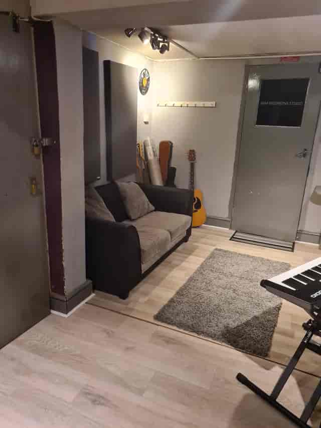 Cozy recording studio with instruments, perfect for creative brainstorming sessions.