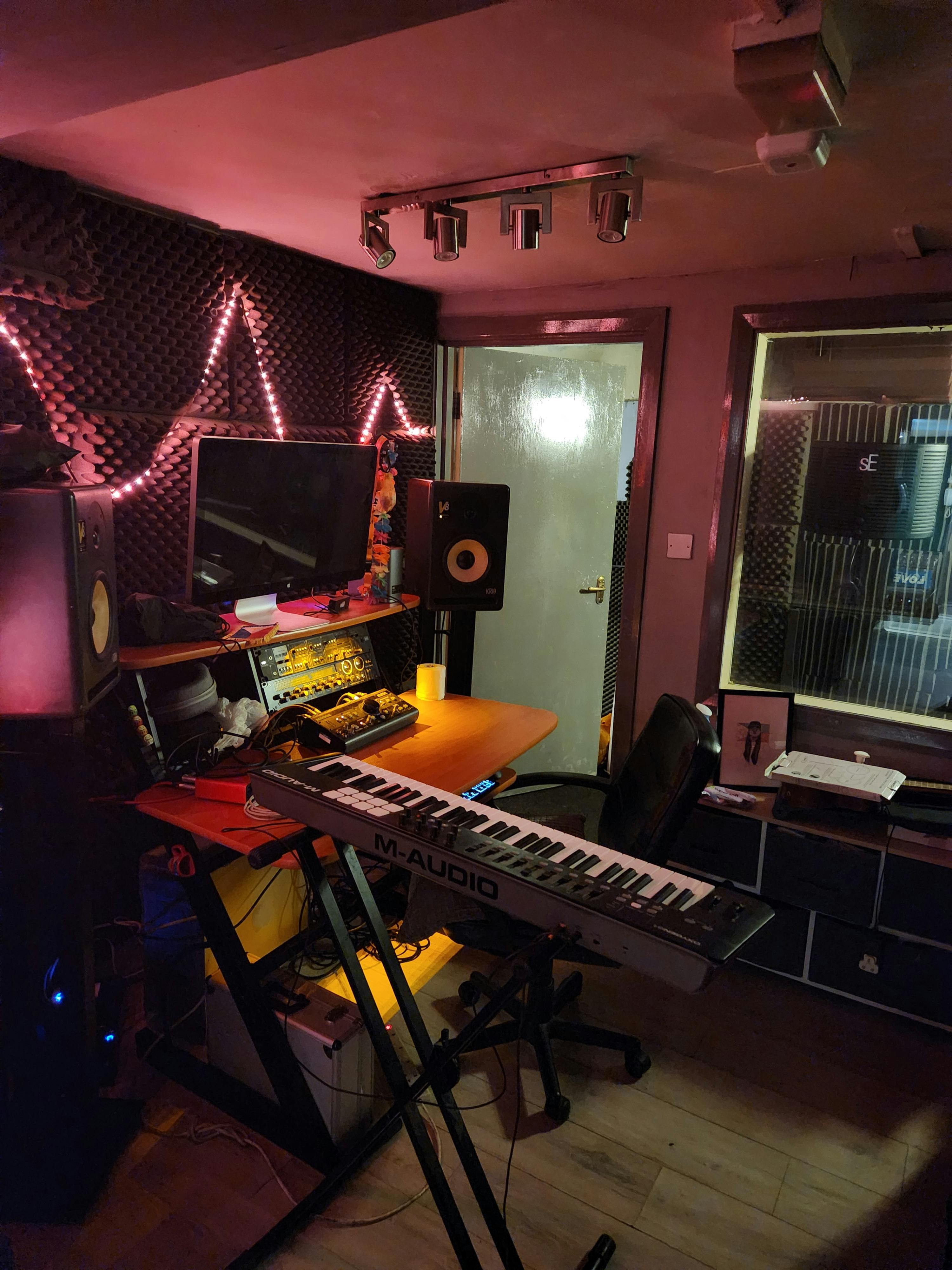 Recording studio with keyboard and soundproofing for creative workshops and events.