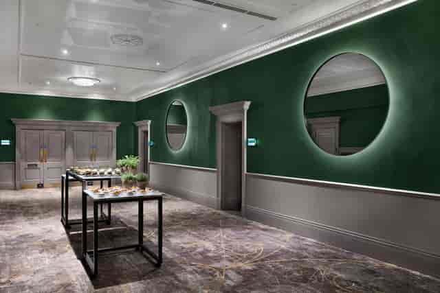 Green walls and backlit mirrors in Bristol Marriott Royal Hotel for networking or coffee breaks.
