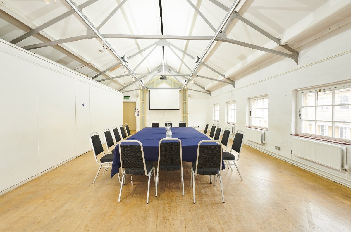 Versatile meeting space in Oxford Playhouse with large table, ideal for workshops and presentations.