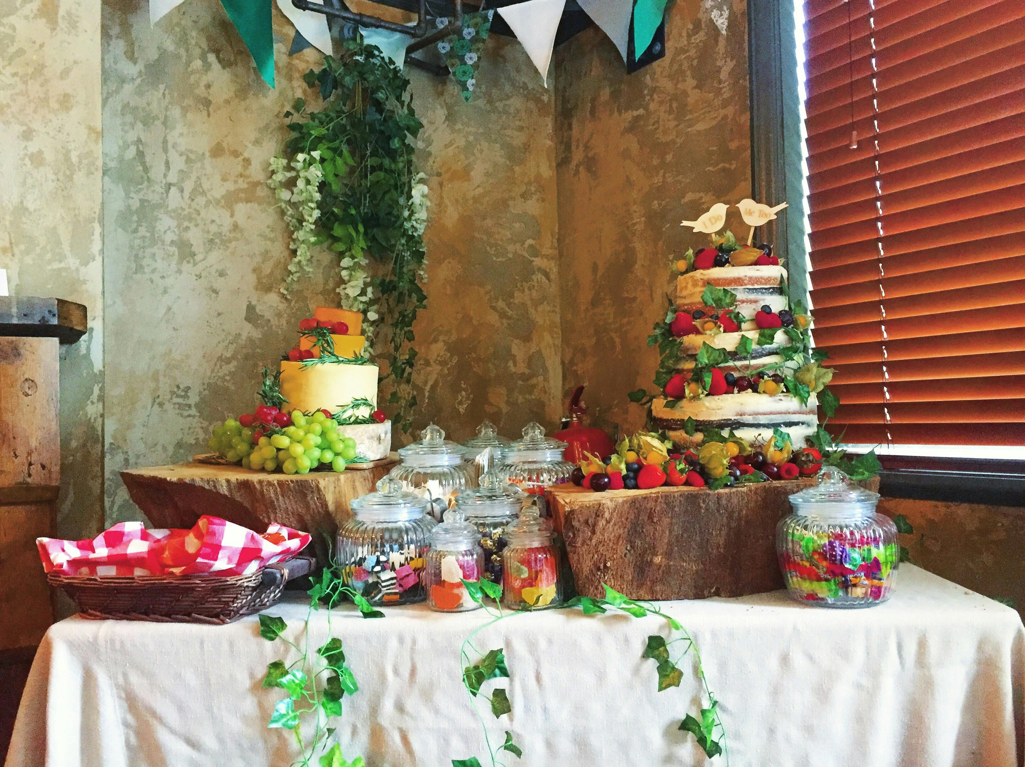 Dessert table with tiered cakes and candies for events at Prince Of Peckham.