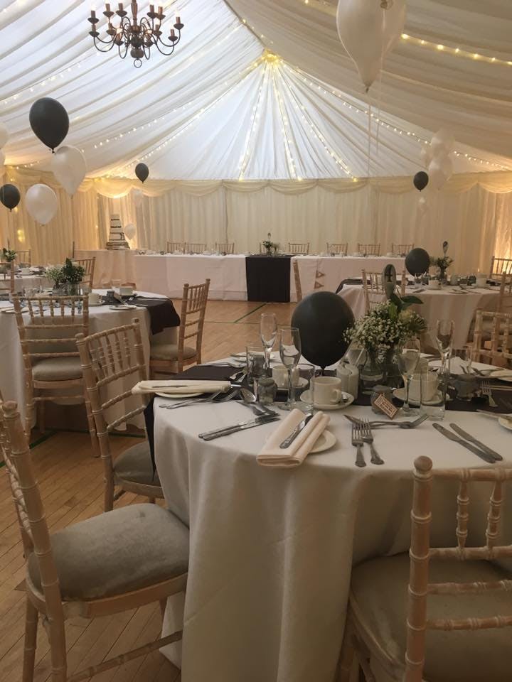 Elegant event space at Gamlingay Eco Hub with beautifully set tables and soft lighting.