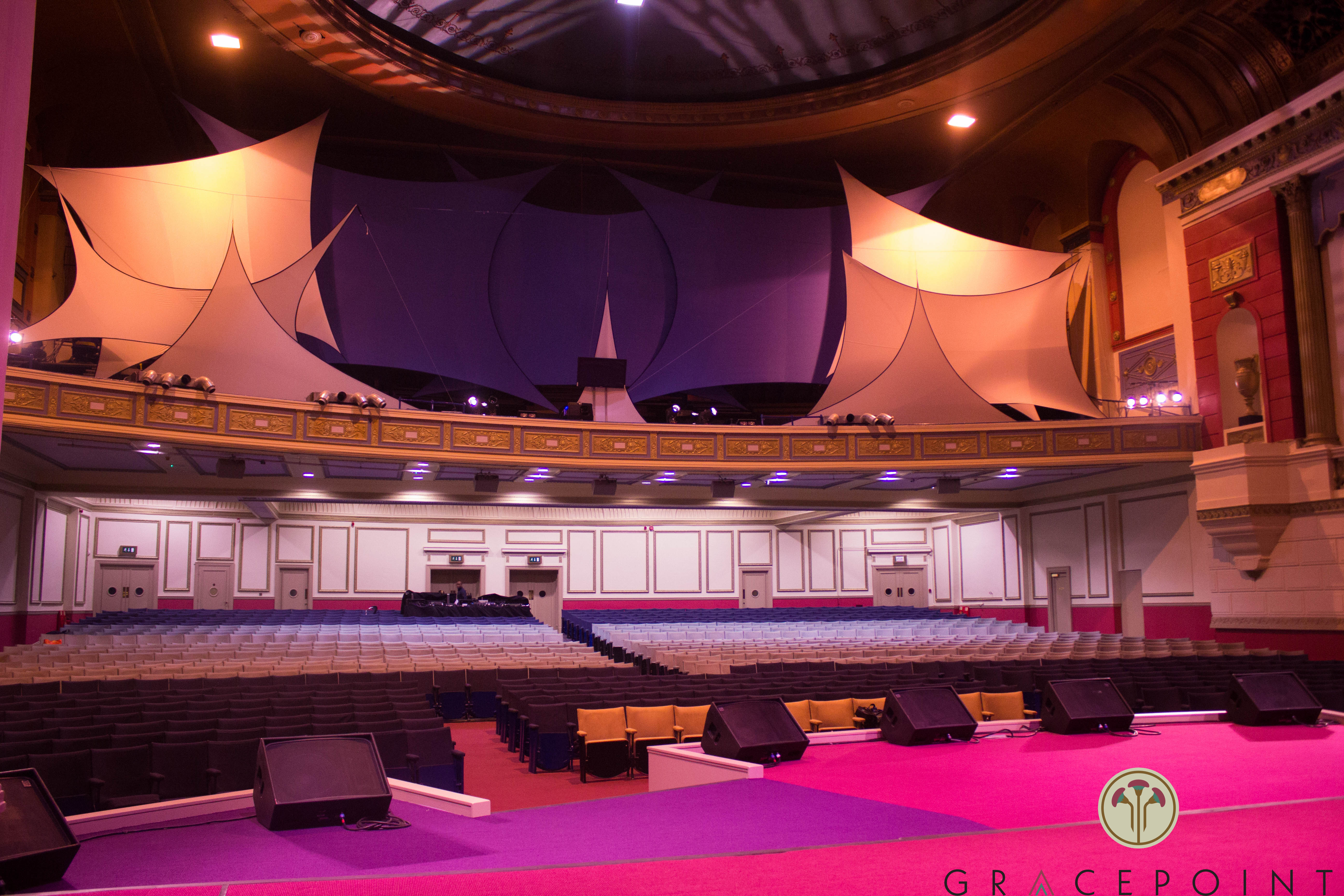 Spacious GRACEPOINT venue with elegant stage, perfect for conferences and performances. - Banner