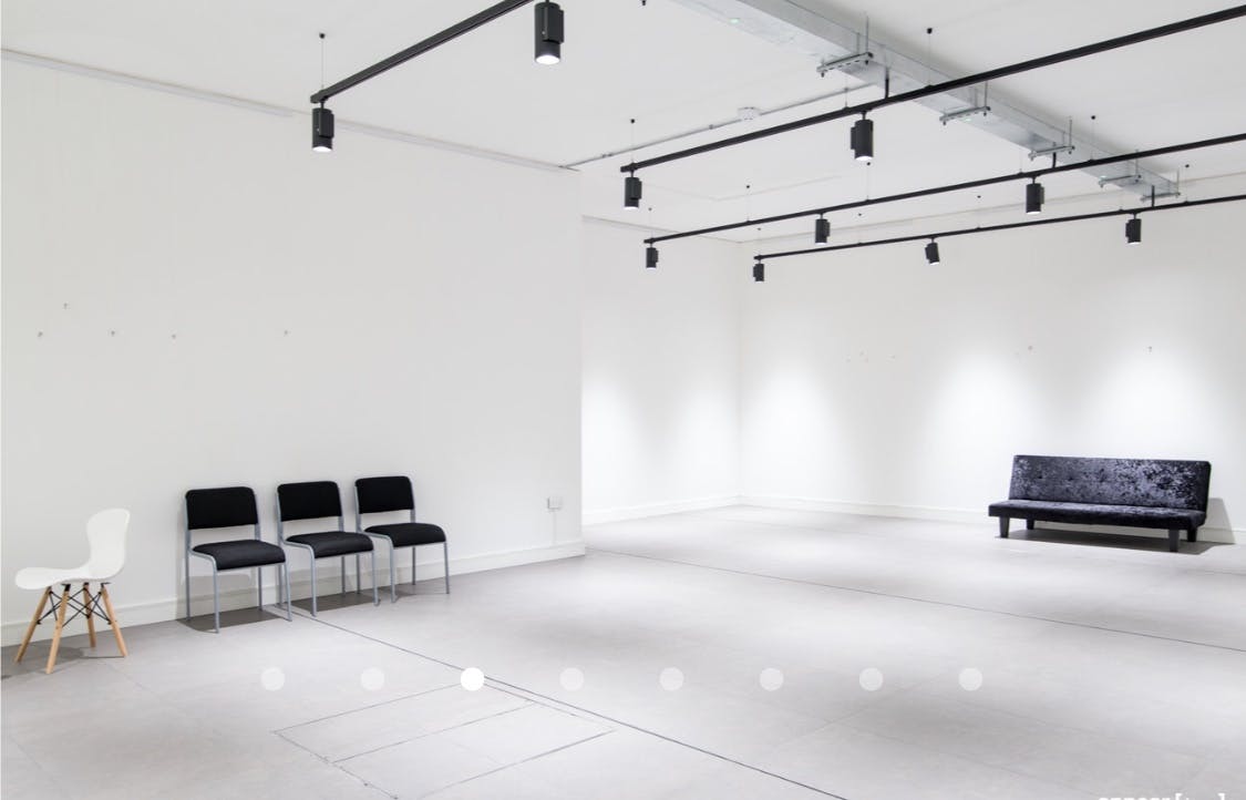 Versatile minimalist event space with flexible seating at The Old Street Gallery.