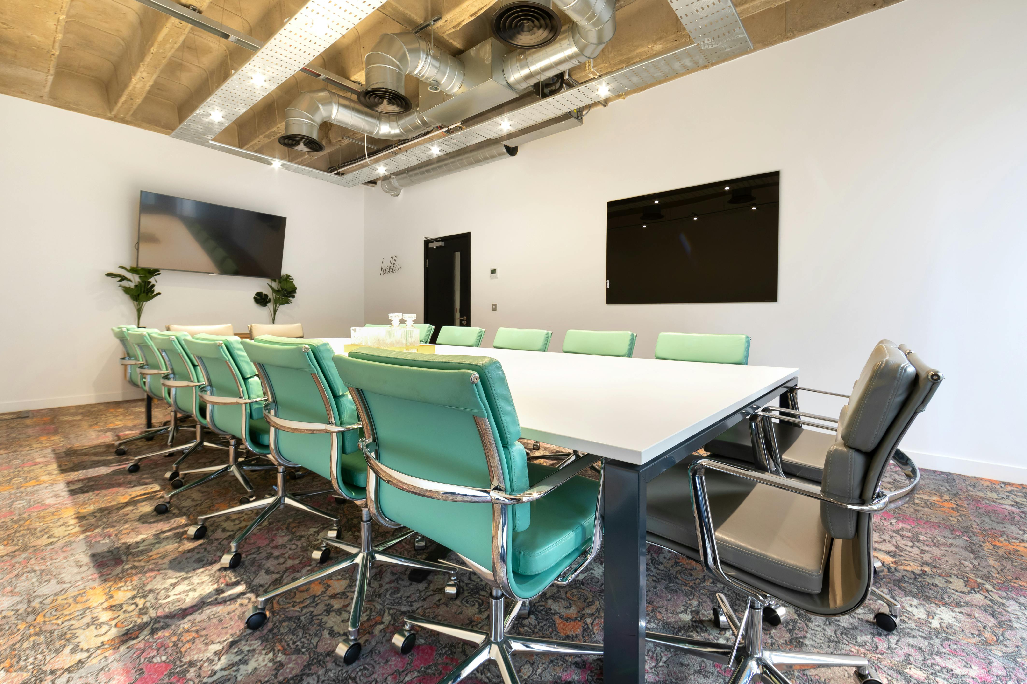 Modern conference room with long table, ideal for corporate meetings and brainstorming.