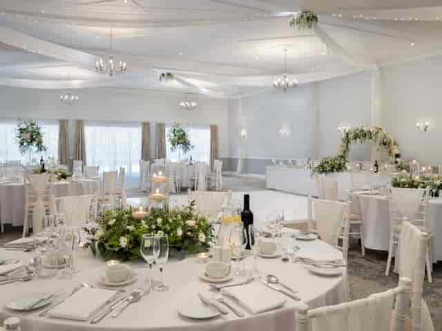 Broughton Suite at Delta Hotels: elegant wedding venue with round tables and floral decor.