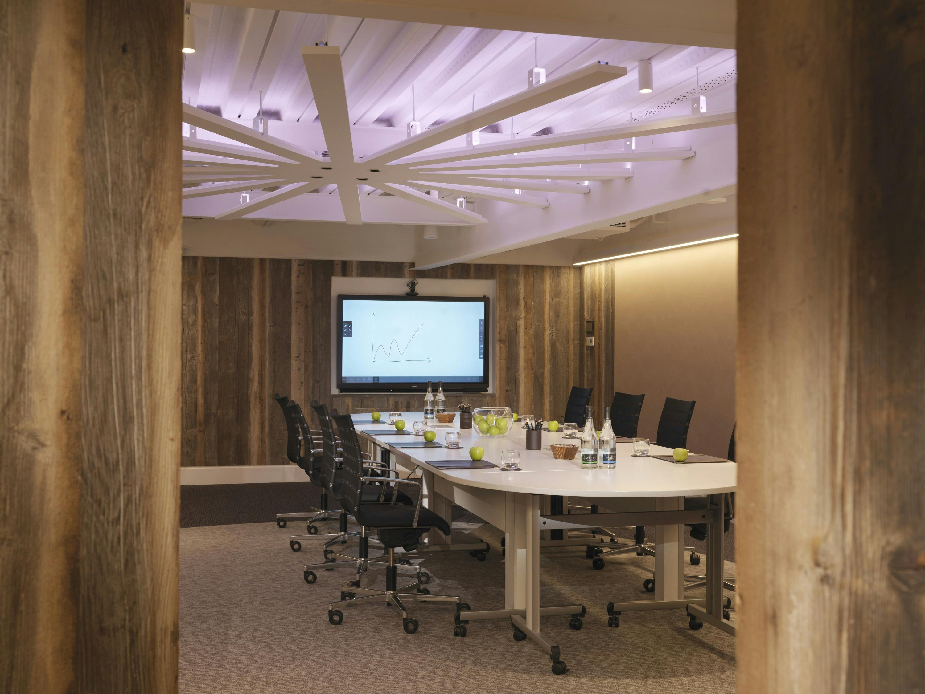 Modern meeting room at Radisson Blu Heathrow with ergonomic chairs and tech setup.