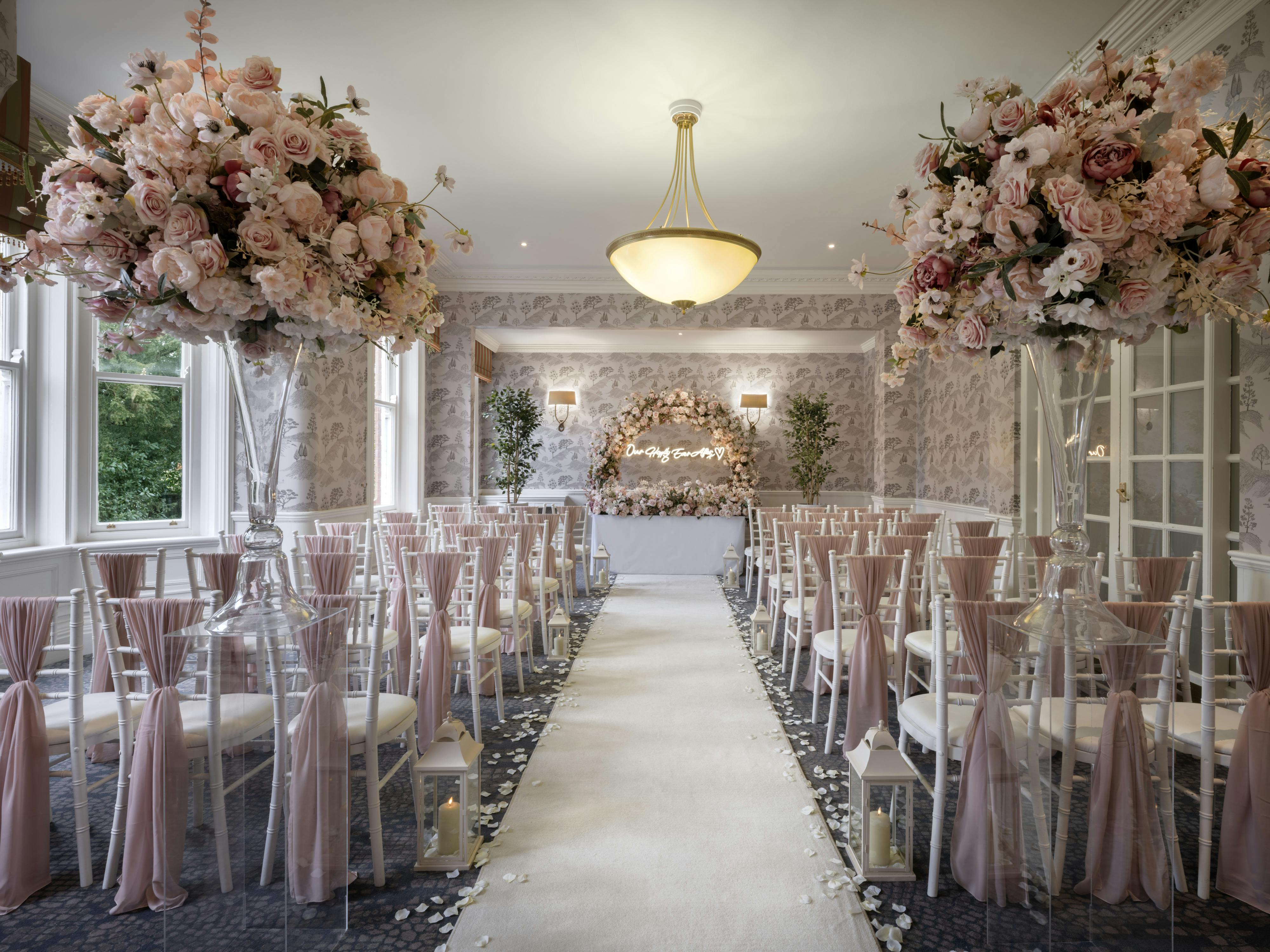 Elegant Garden Room at Delta Hotels, ideal for weddings with floral decor and clear chairs.