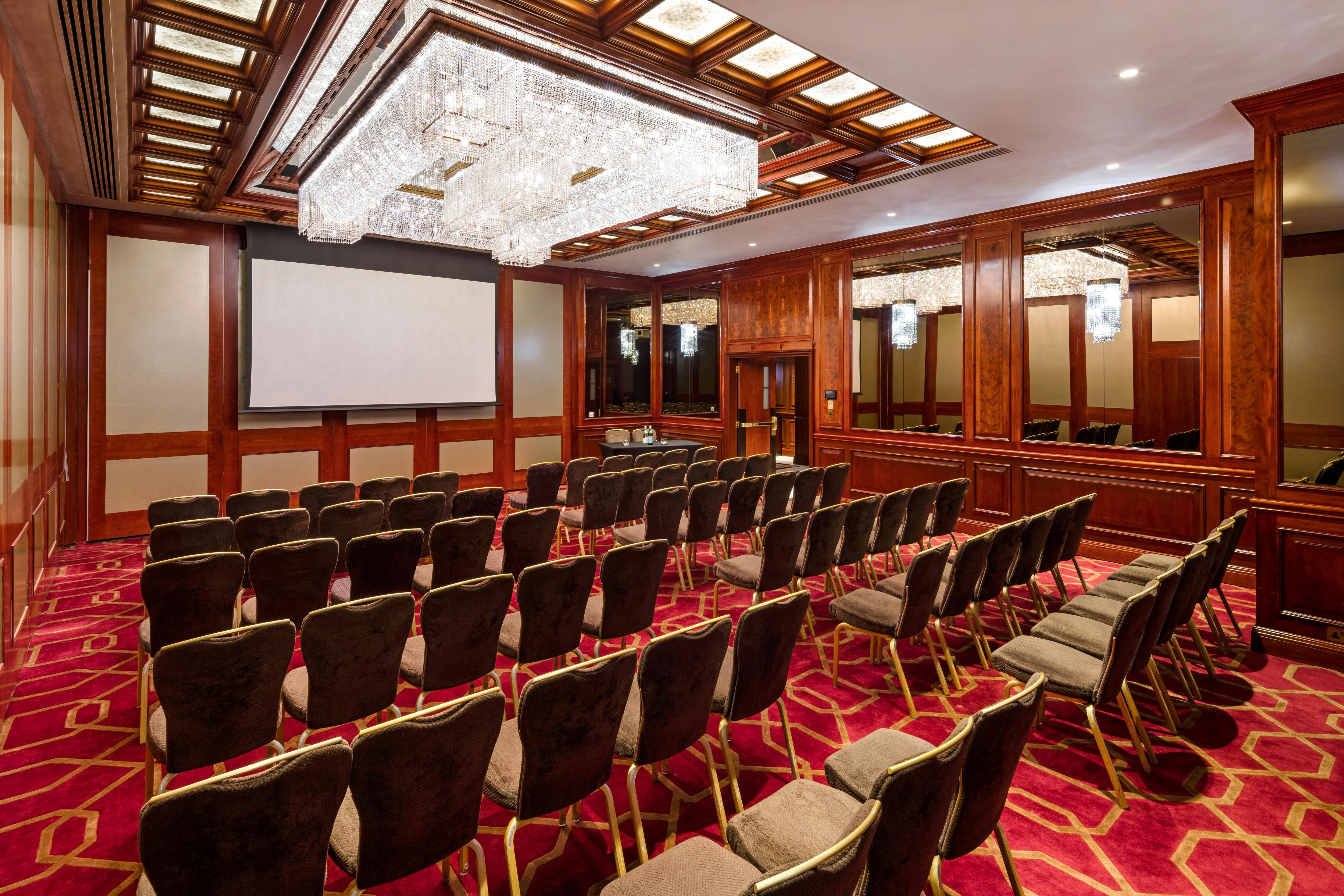 Elegant meeting room with chandelier at Radisson Blu Heathrow for corporate events.