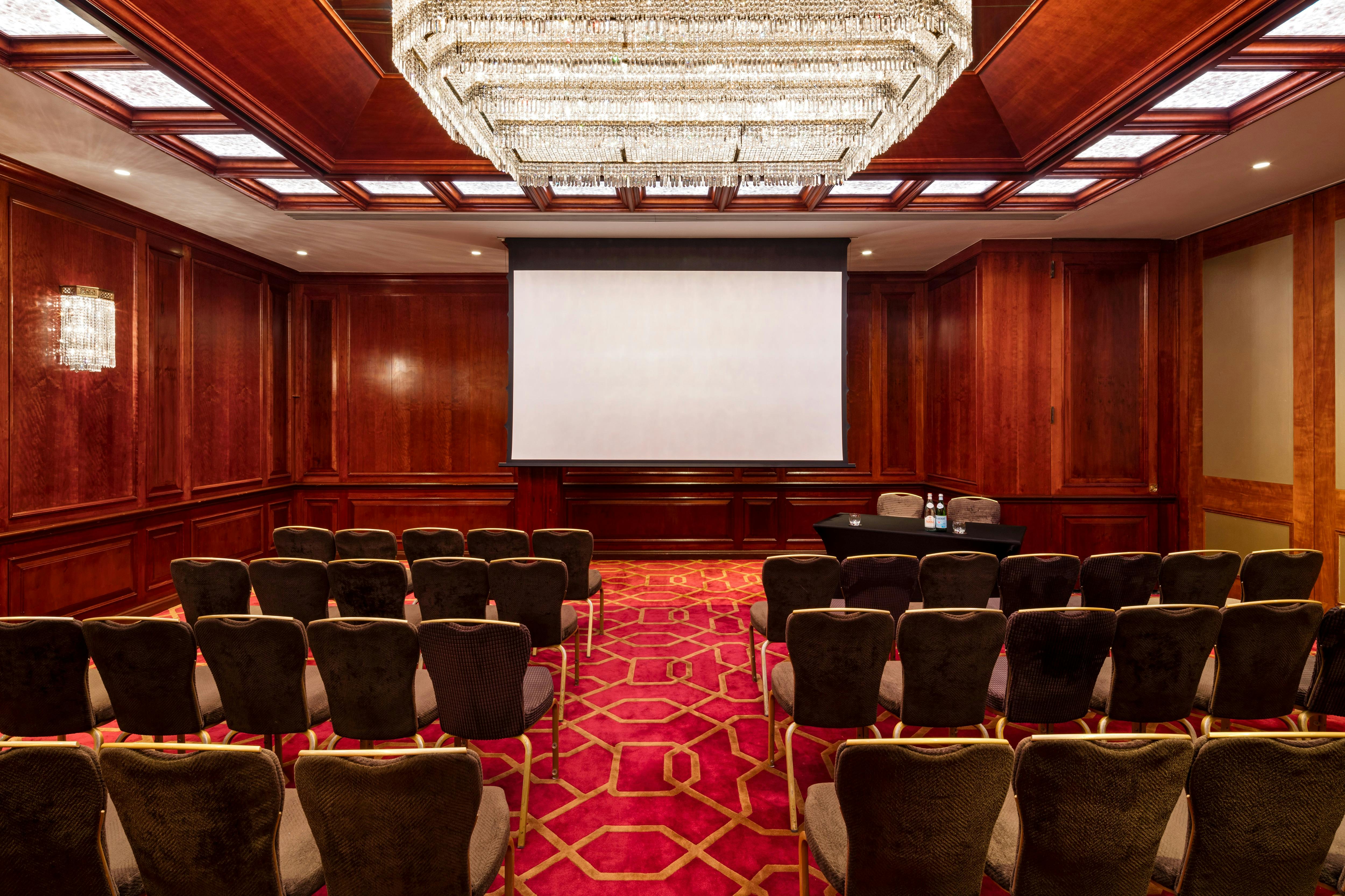 Elegant meeting room at Radisson Blu Heathrow with wood paneling, ideal for conferences.