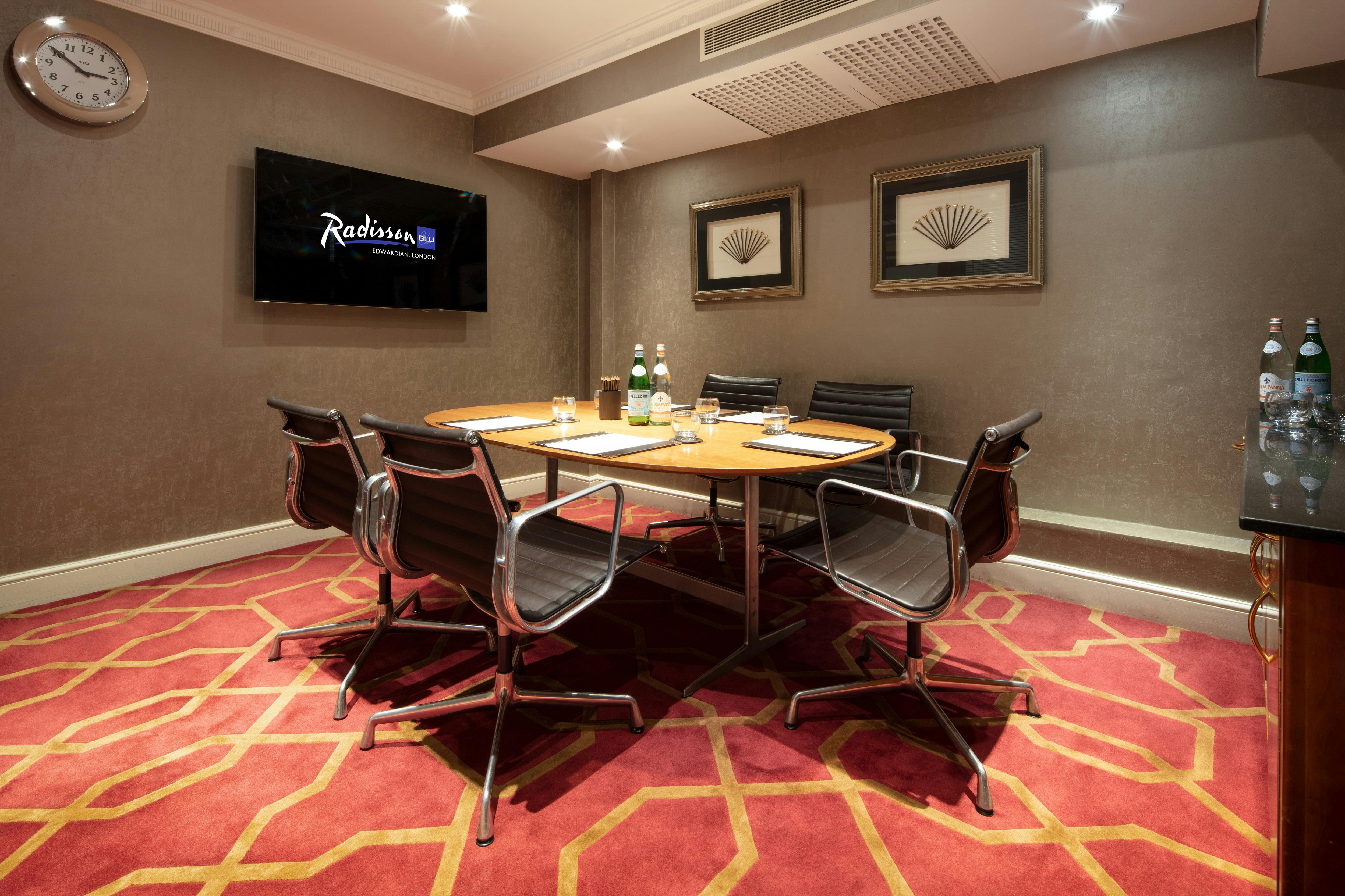 Private Room 15 at Radisson Blu Heathrow, featuring a polished wooden table for corporate meetings.