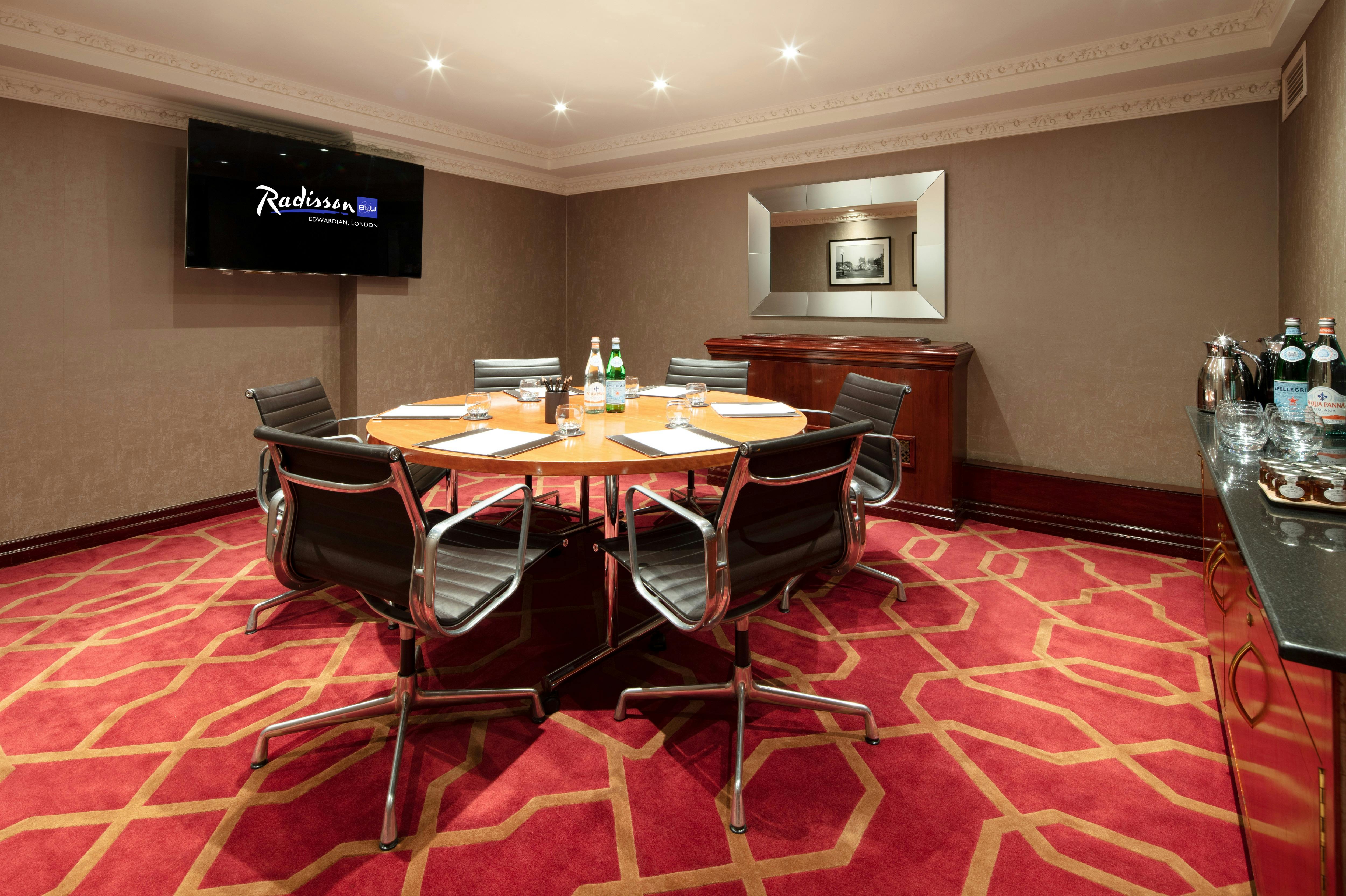 Private Room 17 at Radisson Blu Heathrow, ideal for executive meetings with round table.