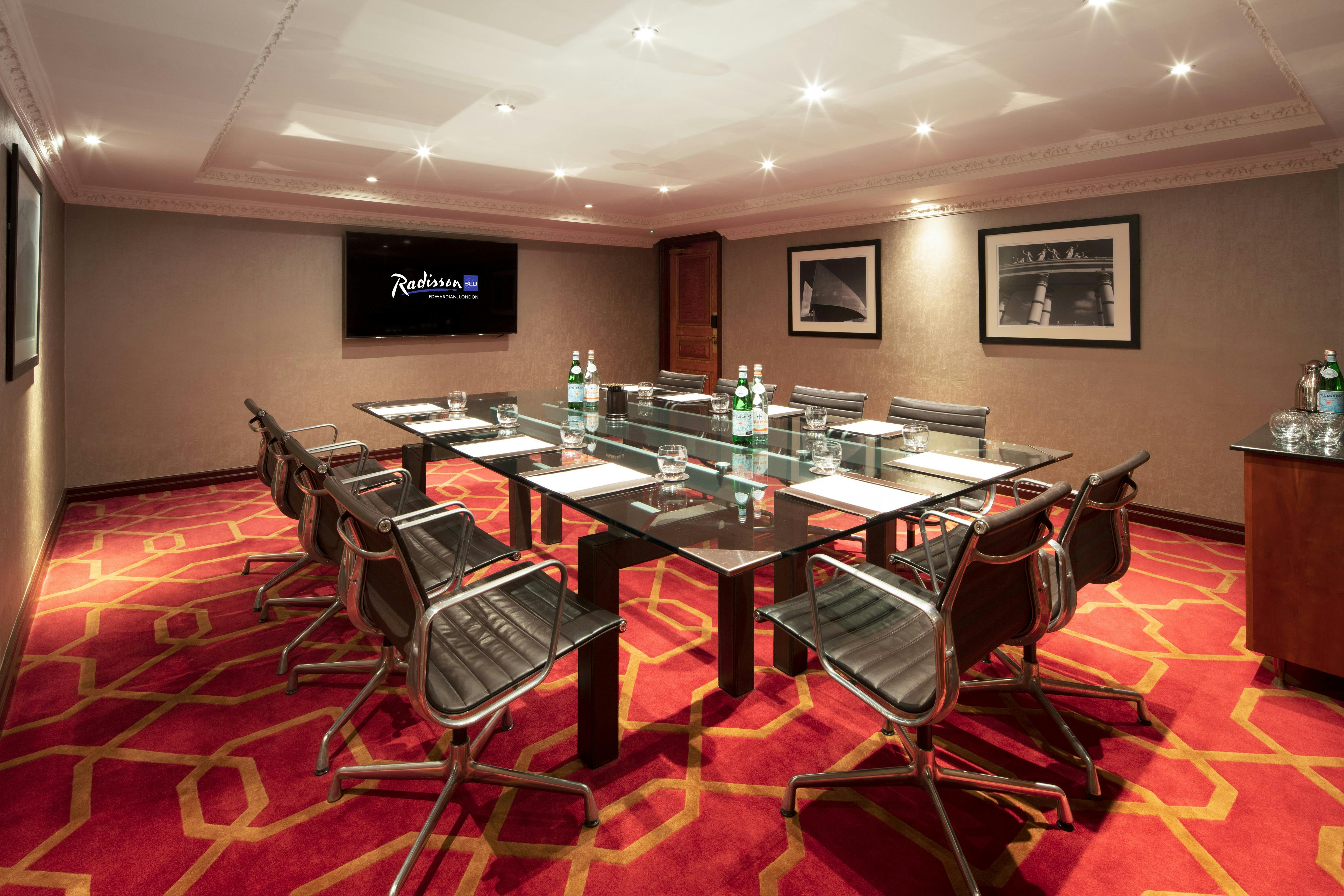 Private Room 19 at Radisson Blu Heathrow, sleek glass table, ideal for corporate meetings.