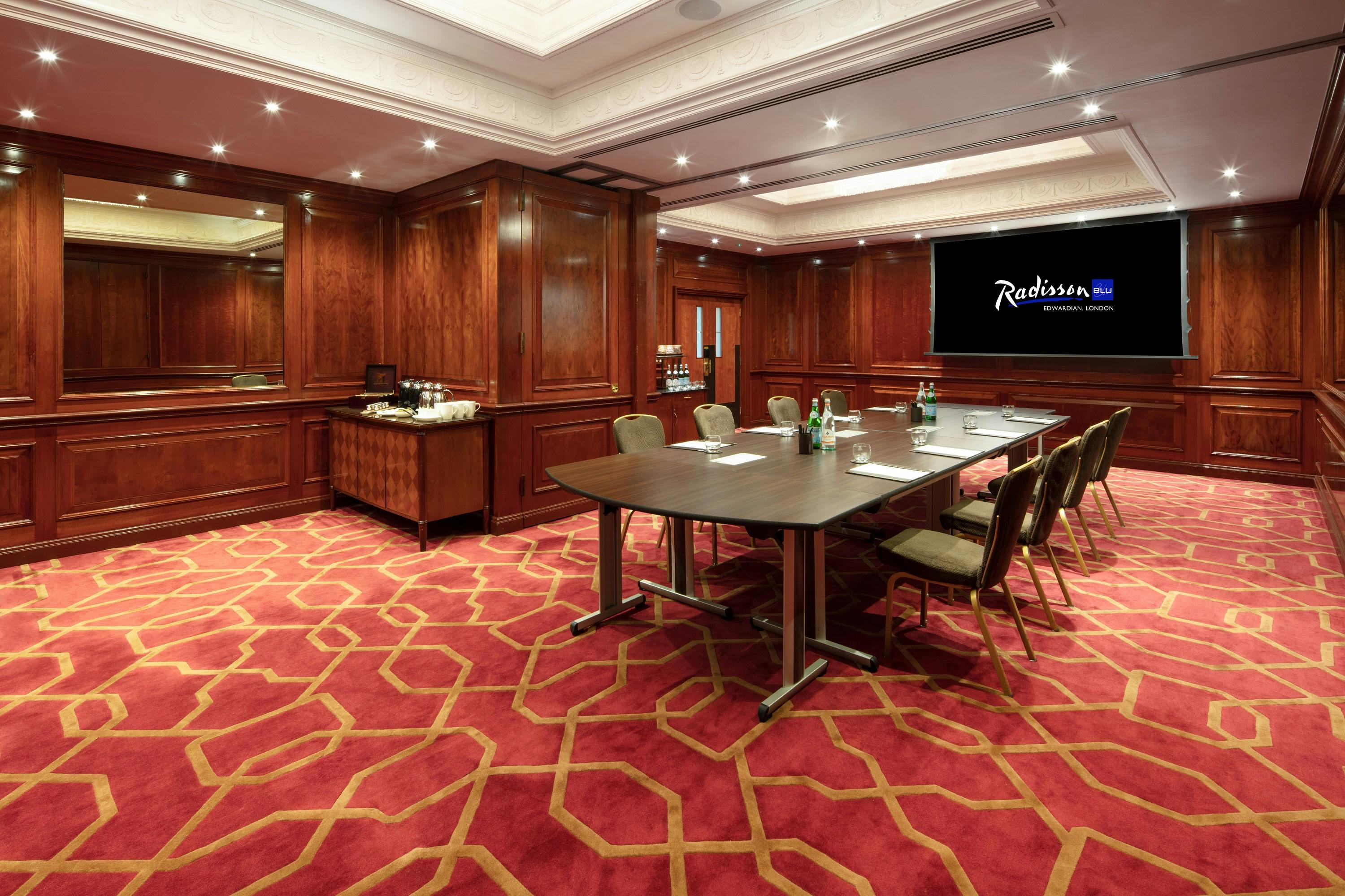 Private Room 34 at Radisson Blu Heathrow, featuring wooden paneling for corporate meetings.