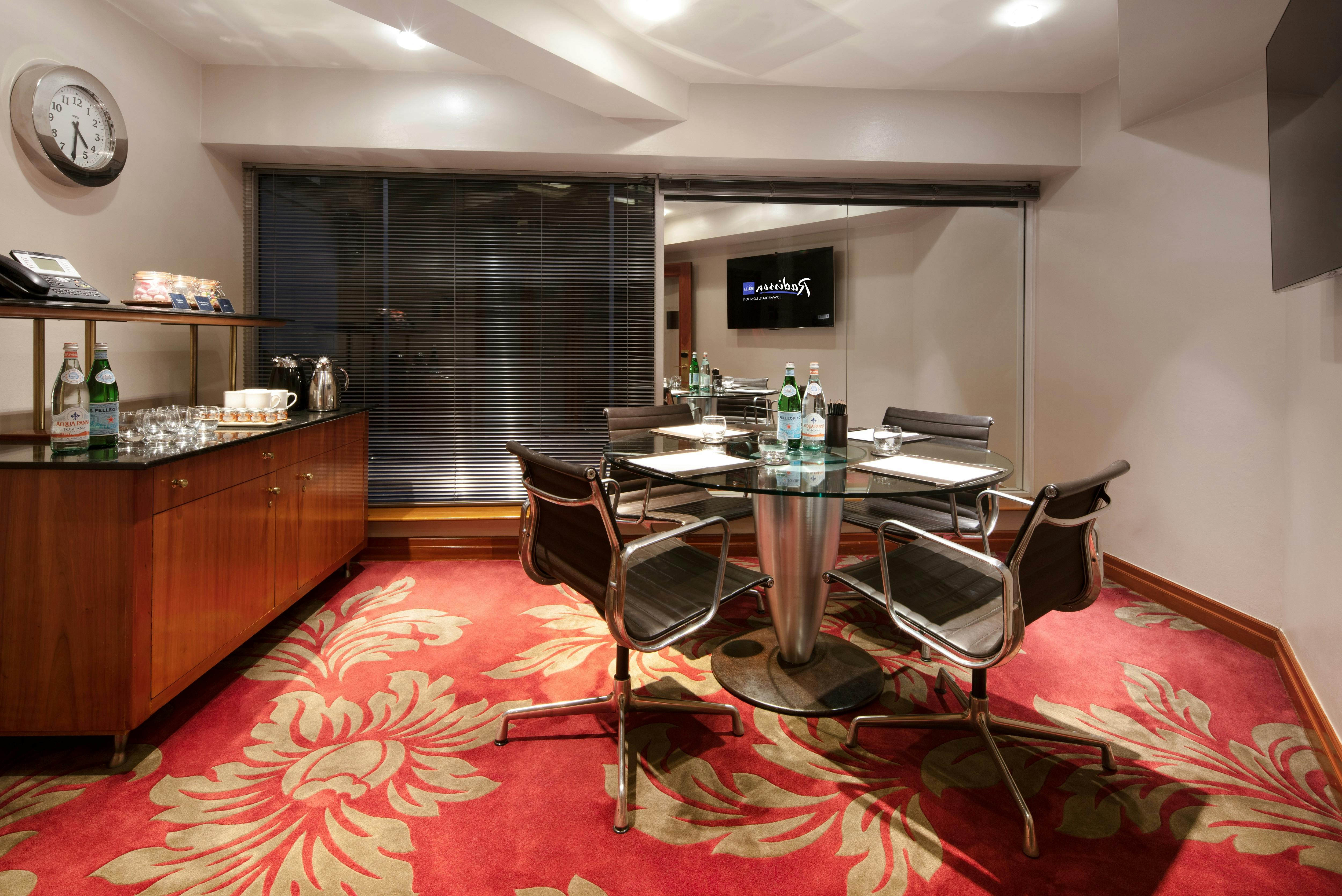 Modern meeting room with glass walls at Radisson Blu Edwardian Heathrow for intimate gatherings.