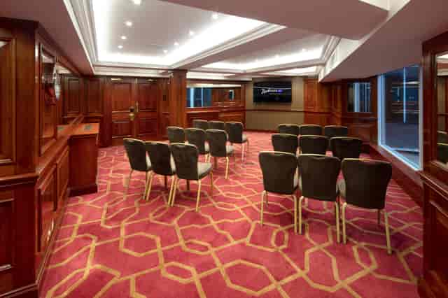 Private Room 40 at Radisson Blu Heathrow, featuring rich wood paneling for corporate meetings.