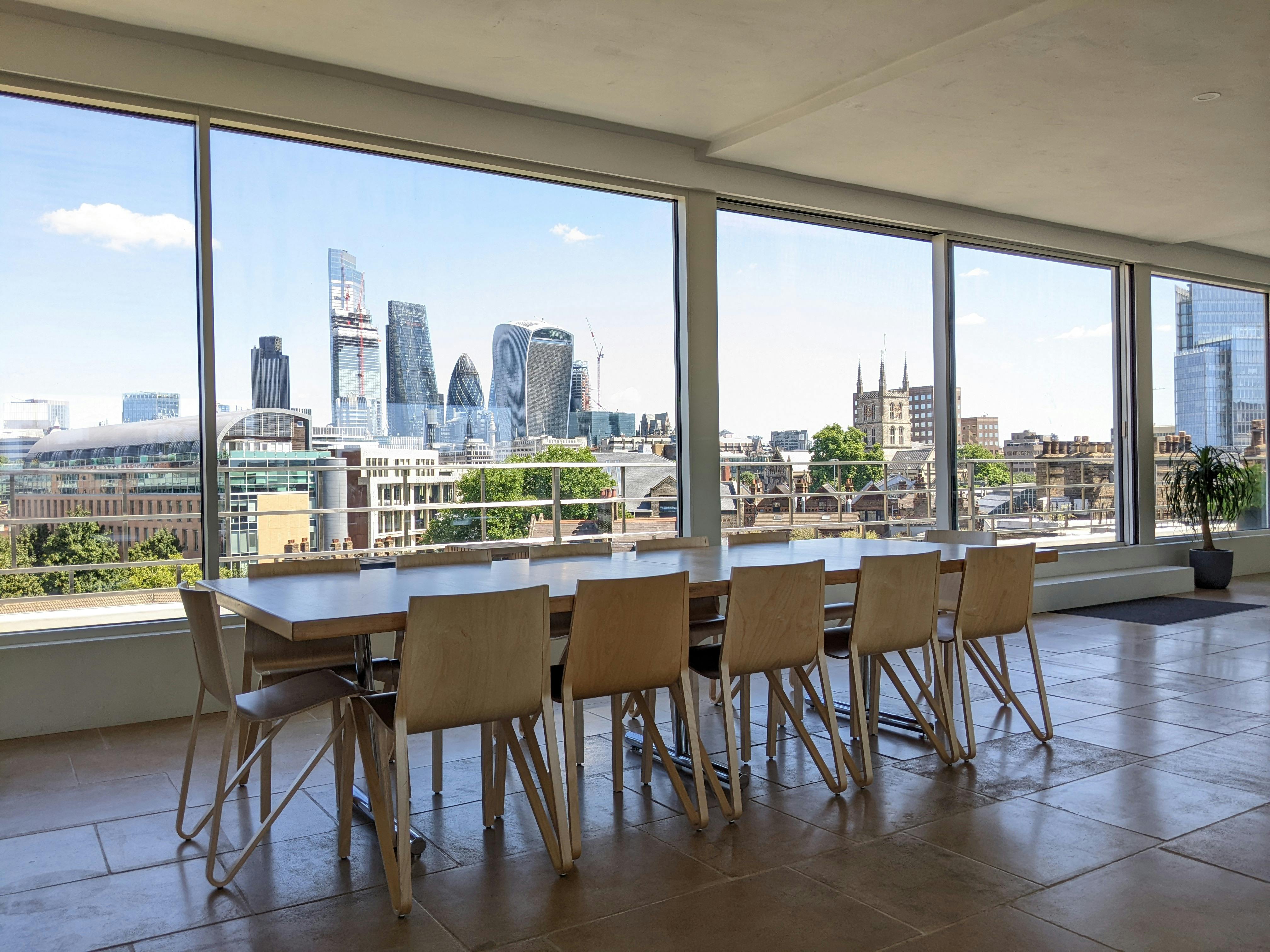 Modern meeting space in Menier Penthouse with skyline view, ideal for corporate events.