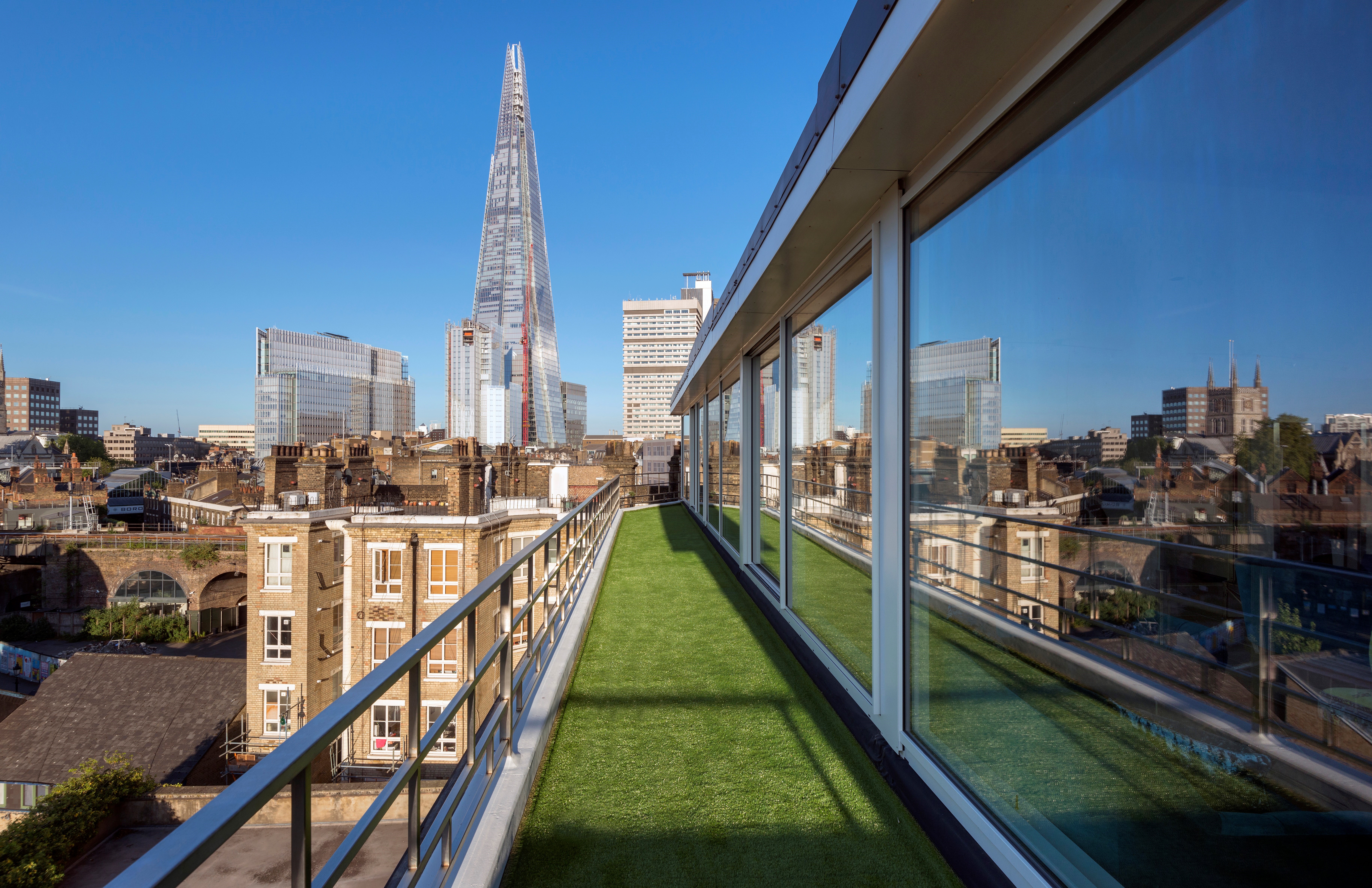 Rooftop terrace at Menier Penthouse with city skyline views for events and networking. - Banner