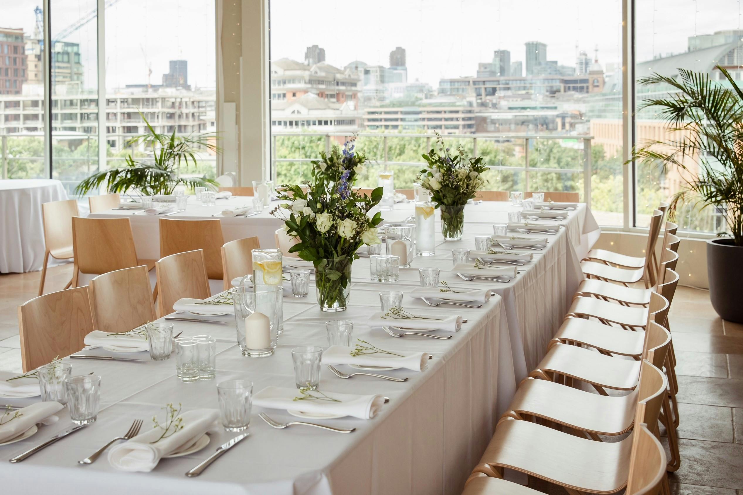 Elegant event space in Menier Penthouse with floral centerpieces, ideal for weddings and corporate events.