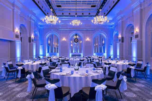 Elegant Baccarat event space in Hilton Paris Opera with round tables, ideal for galas.