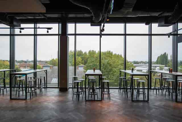 Modern event space at Allianz Stadium with tall windows, ideal for networking and gatherings.