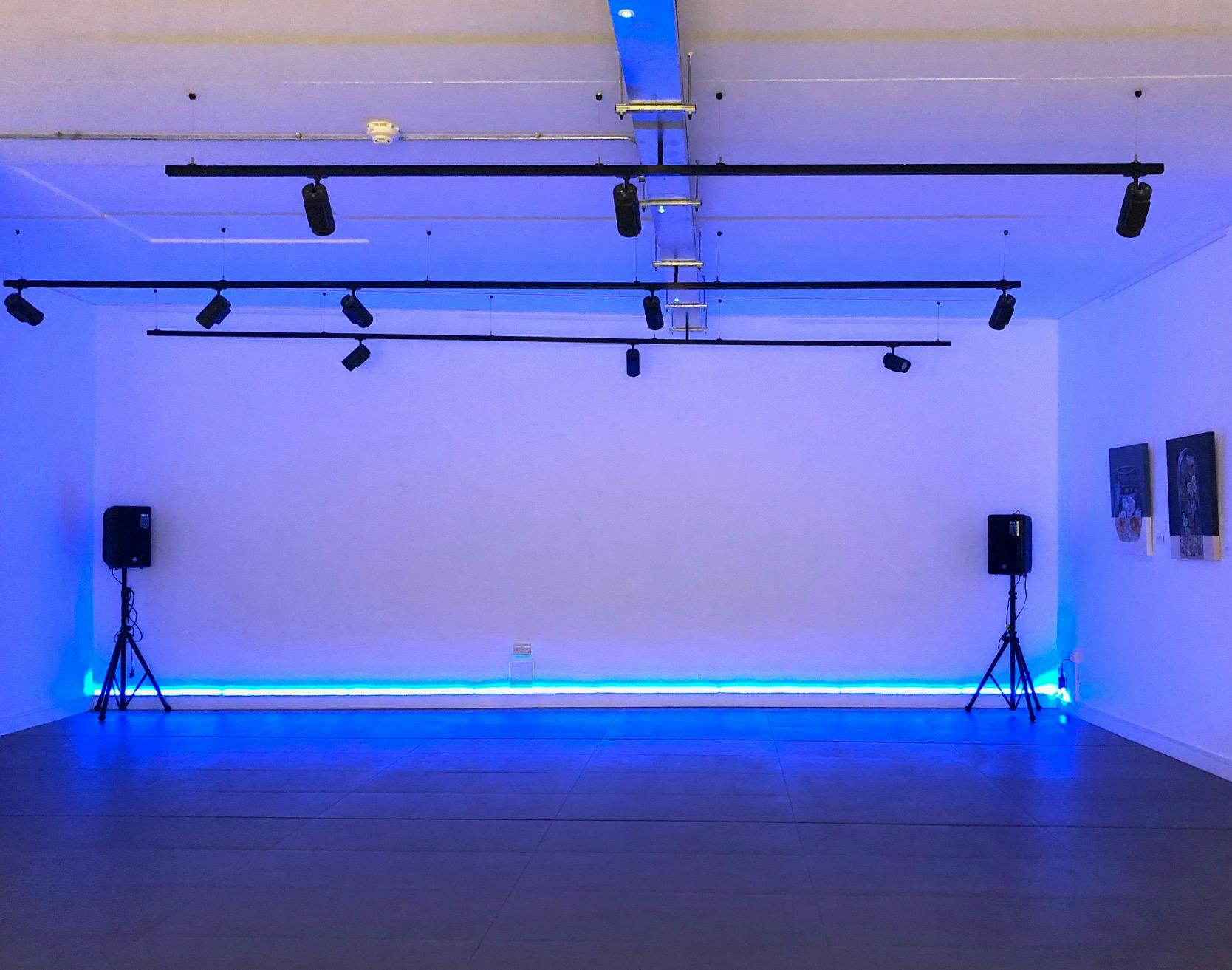 Versatile event space in The Old Street Gallery with minimalist design for workshops and gatherings.