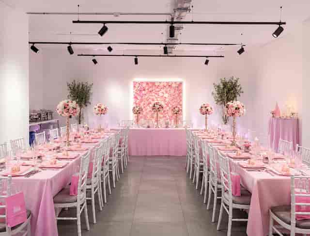 Old Street Gallery bridal shower setup with pink floral wall for intimate social events.