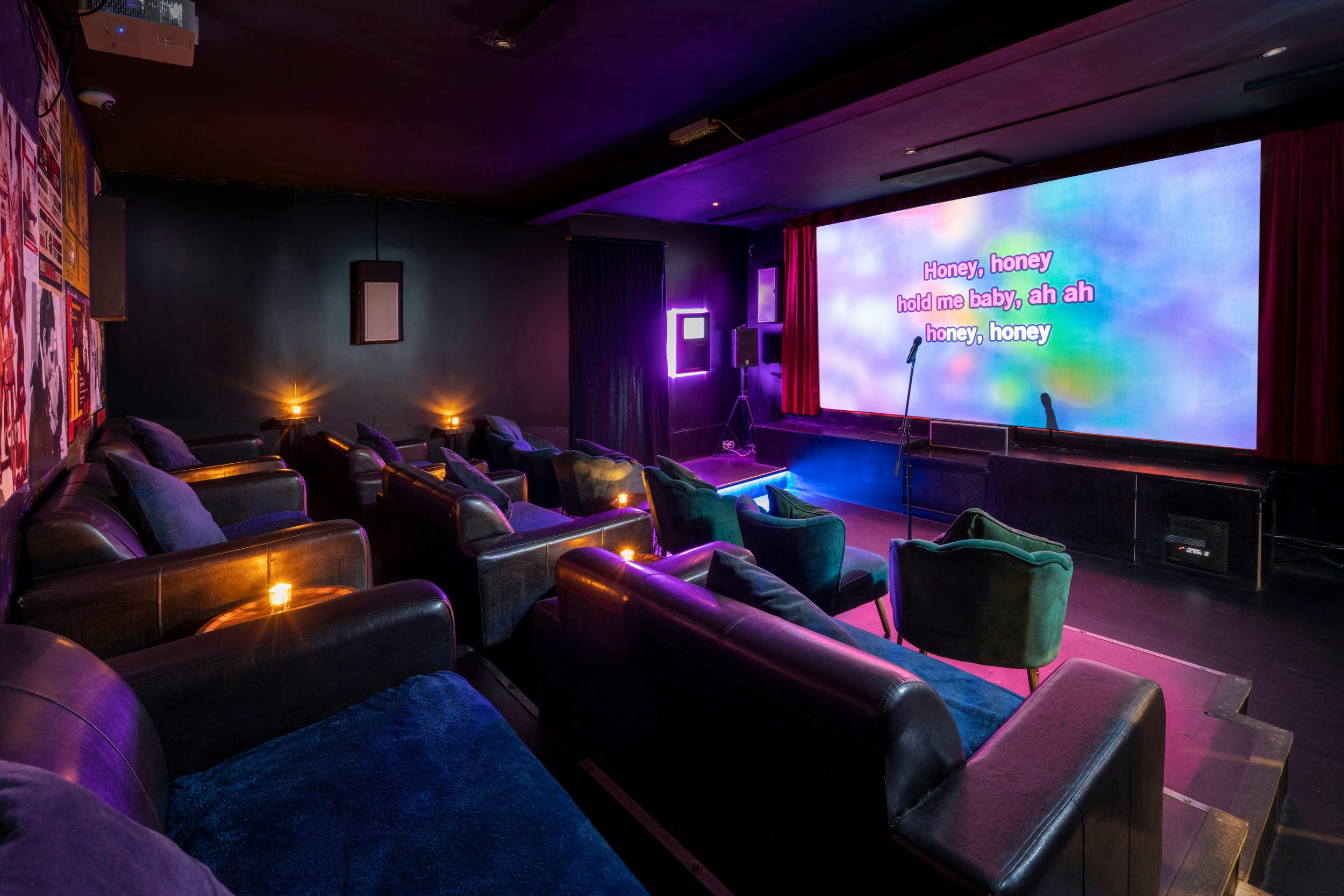 Stylish karaoke room with plush seating for corporate events and gatherings.