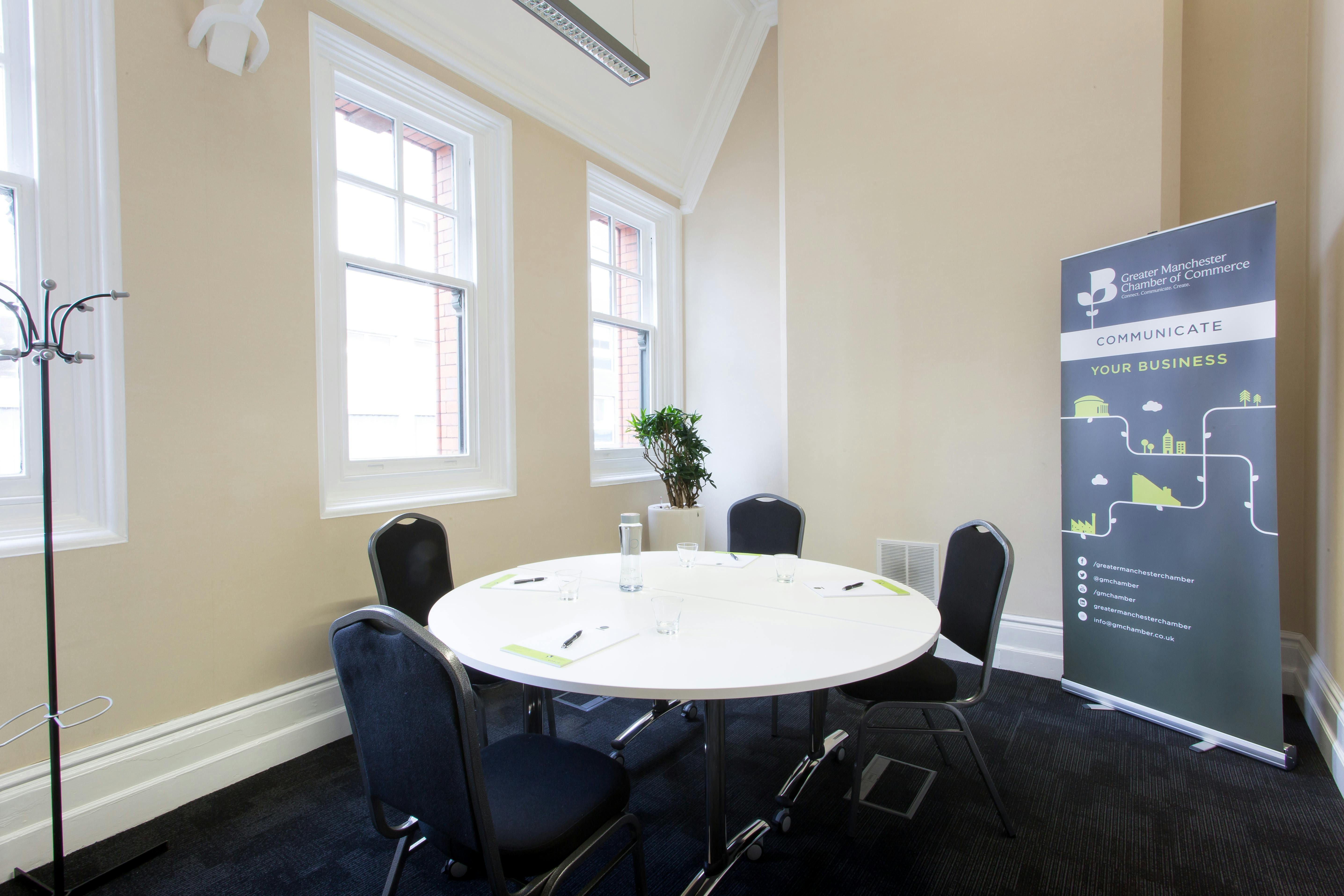 Rutherford Room: bright meeting space with round table for small gatherings and events.