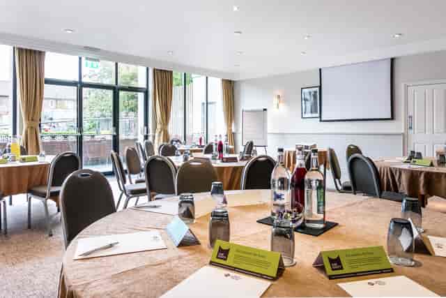 Cheshire Suite meeting space with round tables, ideal for conferences and presentations.