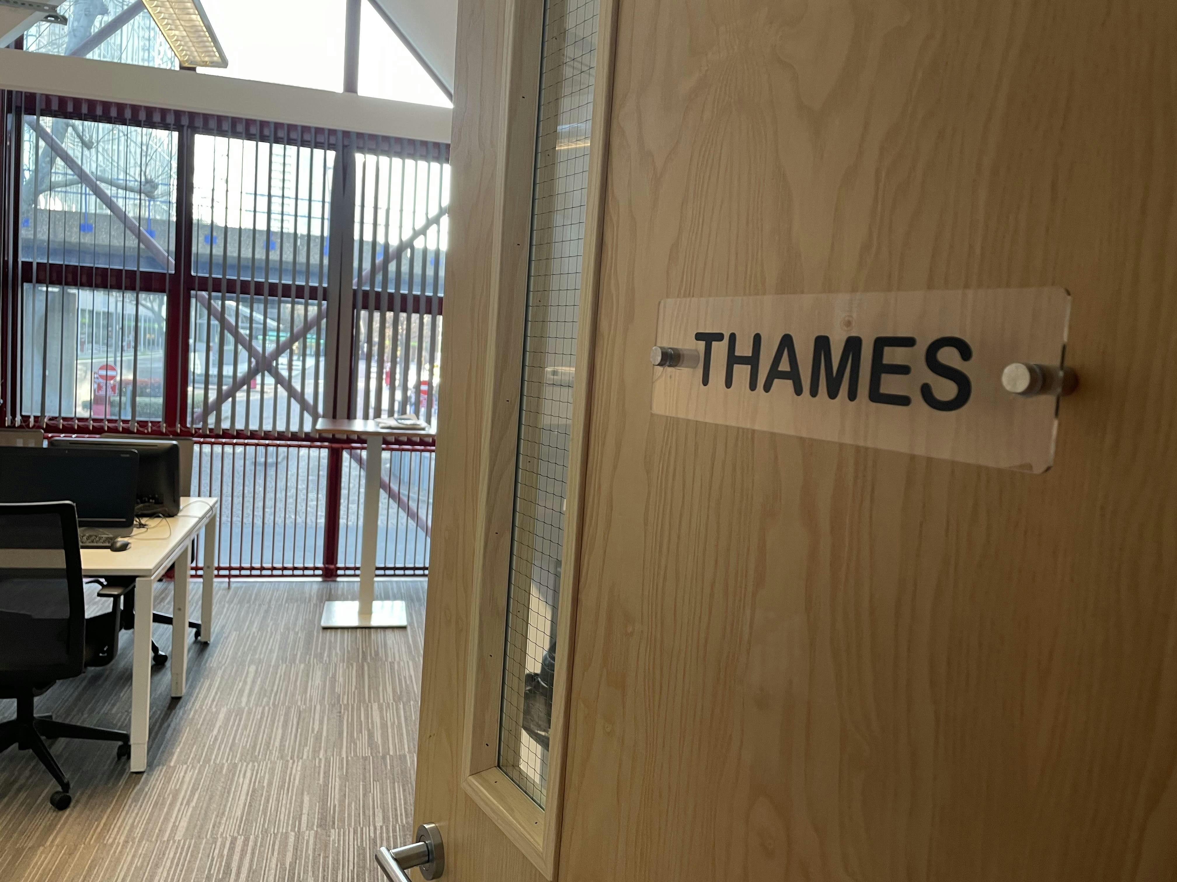 "Suite Thames meeting room entrance with glass door, ideal for professional events."