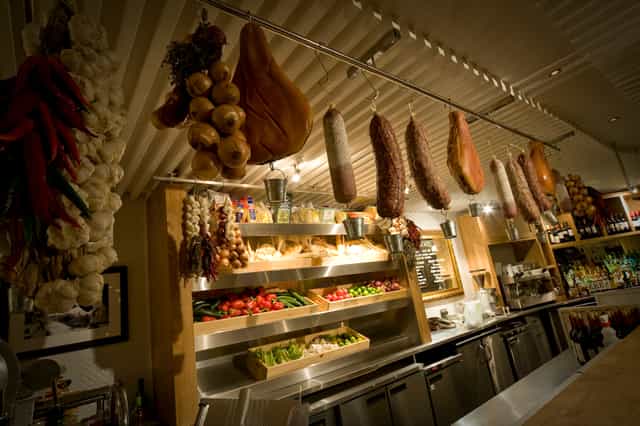 Vibrant culinary display with fresh produce and cured meats at Gusto Italian Cheadle Hulme.
