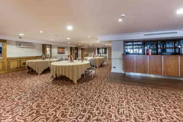 Tatton Suite event space with round tables, ideal for meetings and gatherings.