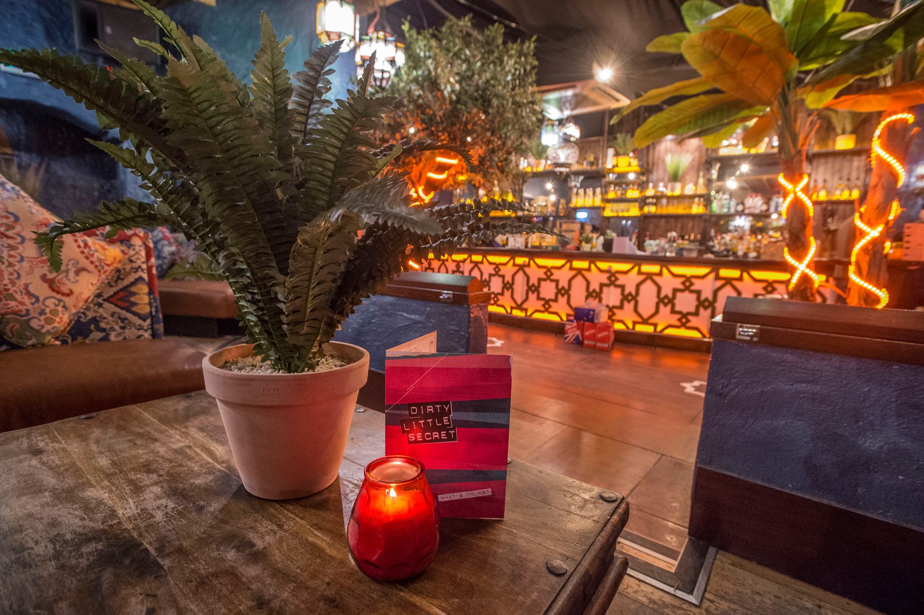 Vibrant event space with cozy decor, ideal for intimate gatherings and social events. - Banner